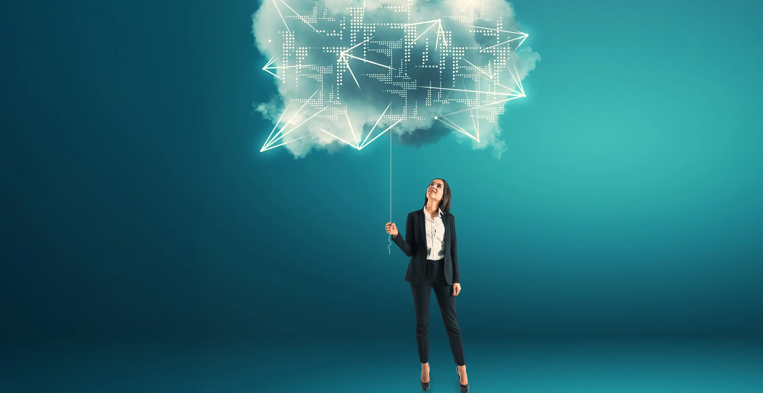 Female executive holding a glowing digital cloud symbolizing control and innovation in hybrid cloud management.